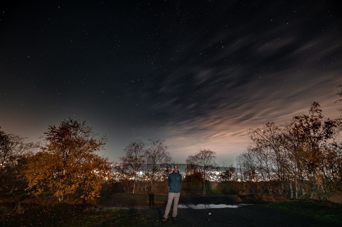 RobinFarr's tweet photo. Moonlit me with the lights of Chapeltown behind and the cosmos above.  30 second exposure at ISO800 with a 10mm lens at F4. https://t.co/KkKPZd31zv