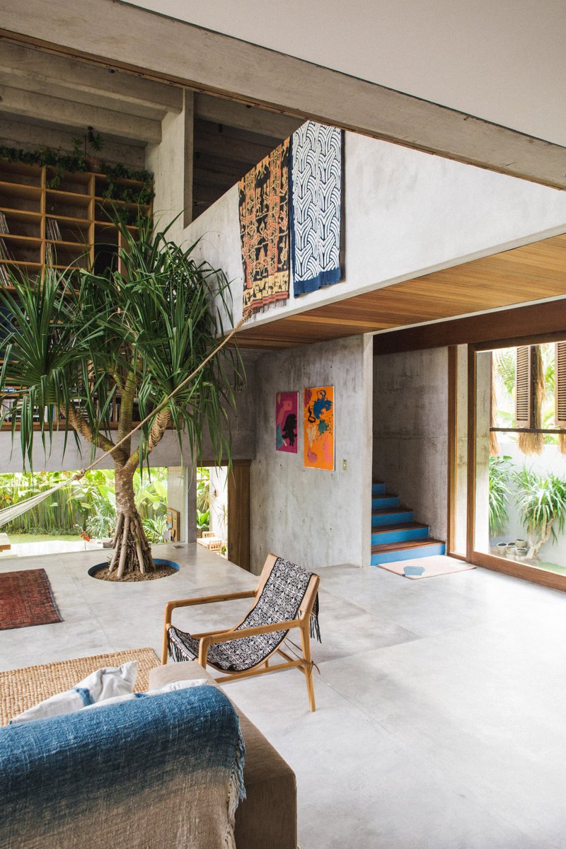 dezeen's tweet photo. A double-height living room stands at the centre of this brutalist house in Bali: https://t.co/jxhQsmELC2 https://t.co/raHyusc4d8