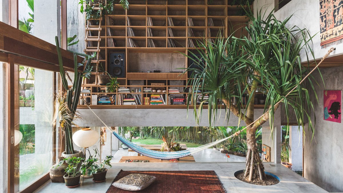 dezeen's tweet photo. A double-height living room stands at the centre of this brutalist house in Bali: https://t.co/jxhQsmELC2 https://t.co/raHyusc4d8