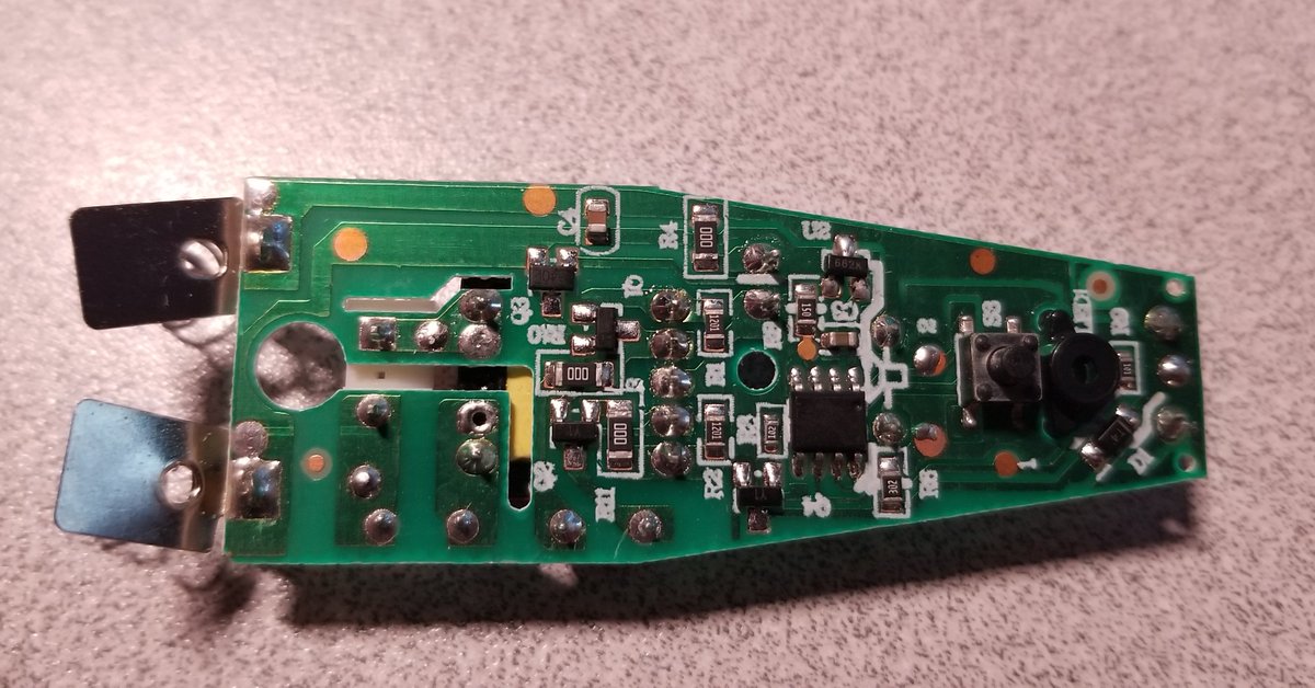 The other site of the PCB.There's a little anonymous 8-pin microcontroller which controls it, the other button, and an LED for the "I'm turned on" light.