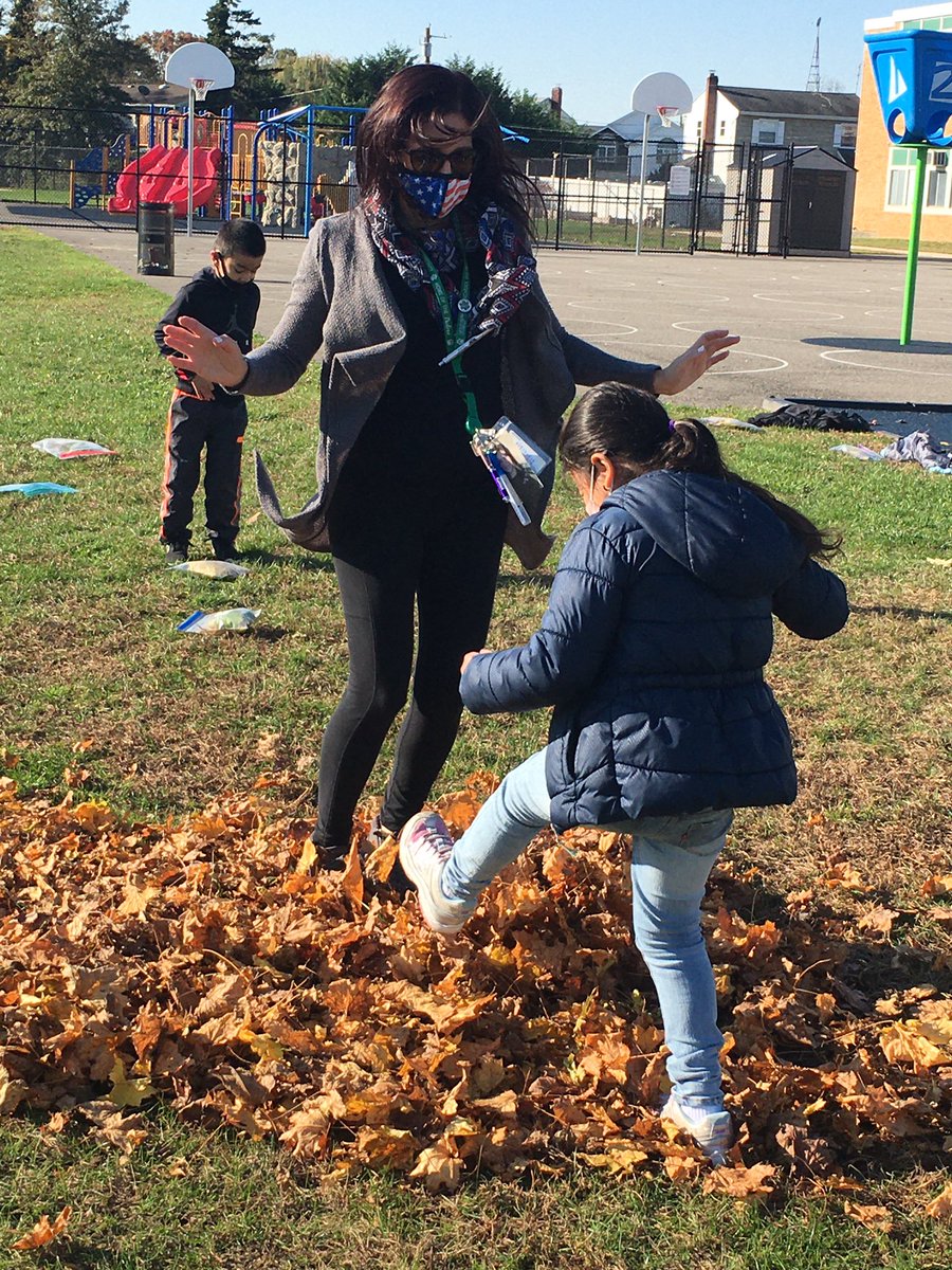 We had a blast learning about how leave change in Fall. And what better way to learn Fall vocabulary than to “rake” the “leaves” into a “pile” and JUMP? Smiles easily seen through 😷.