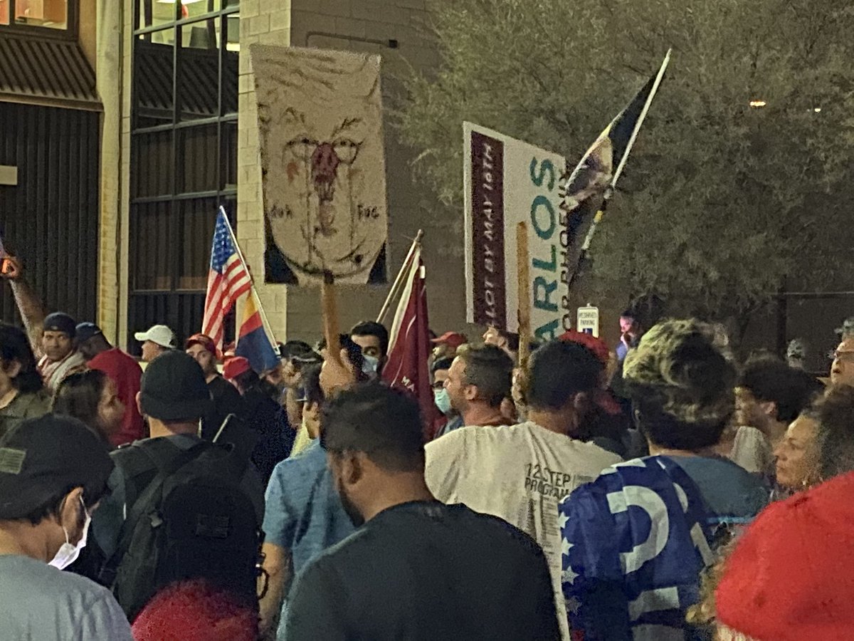 A couple anti-Trump protestors have arrived with signs.