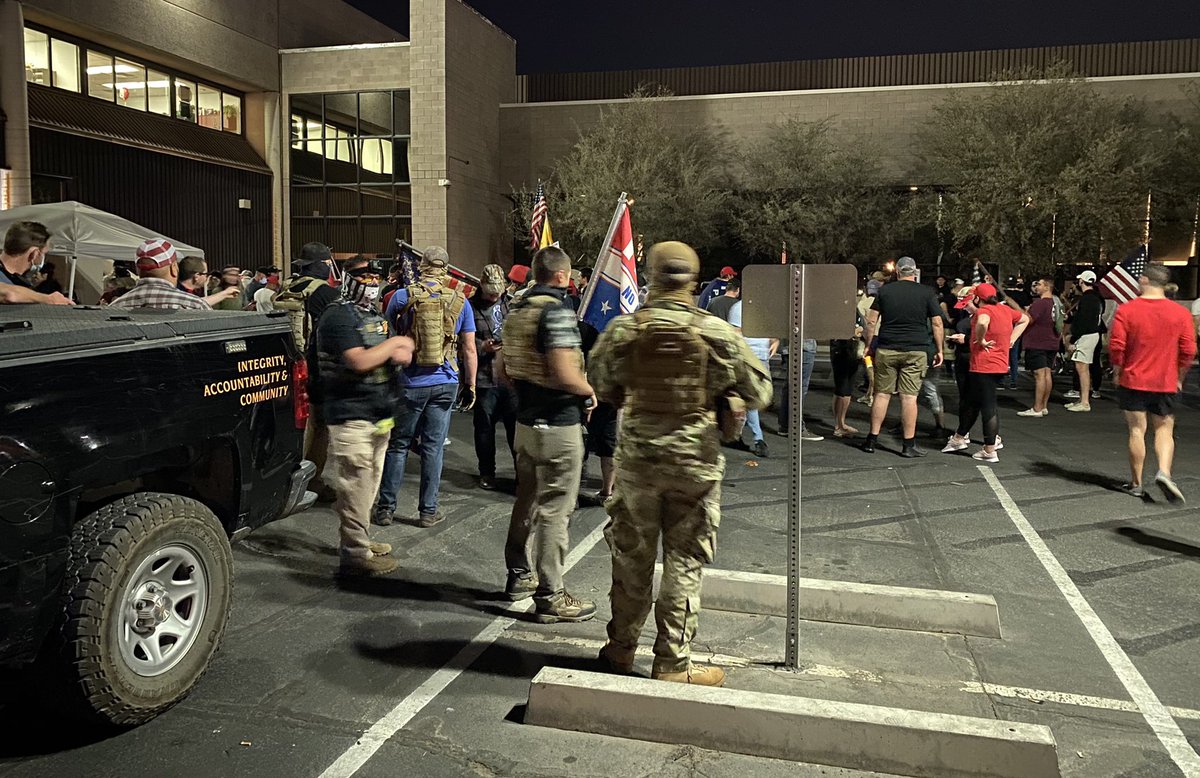 Definitely more than ten armed civilians geared up as counter-protestors continue to drive around the block, honking at them.