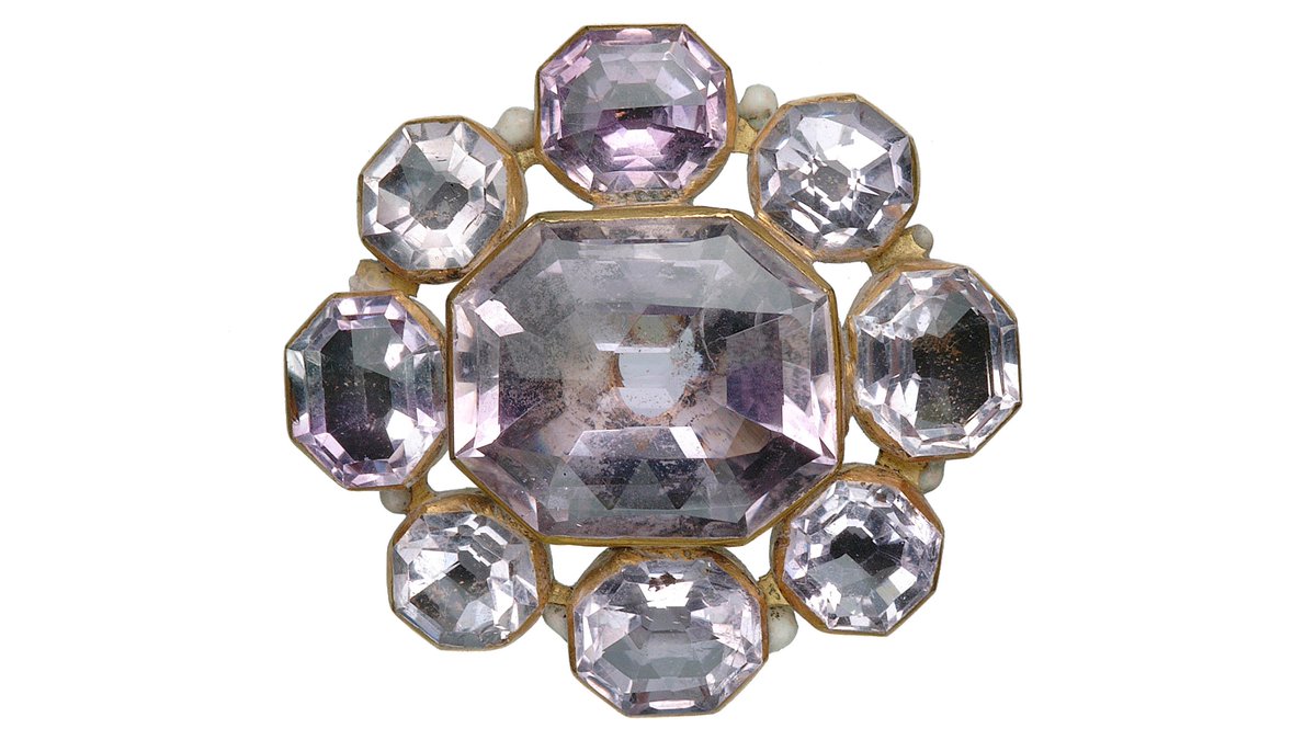 The purpose of this elaborate jewel is unclear, as it has no discernable loops or fastenings. It consists of an openwork octofoil of gold and enamel with nine foiled amethysts in octagonal bezels. It’s enamelled on the reverse in black and white.