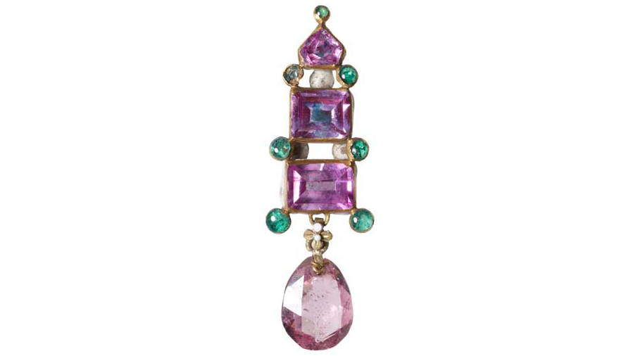 This piece of historical bling is an enamelled gold earring or pendant set with three pink sapphires and seven small round emeralds, although one is sadly missing. A pale-pink briolette spinel hangs below.