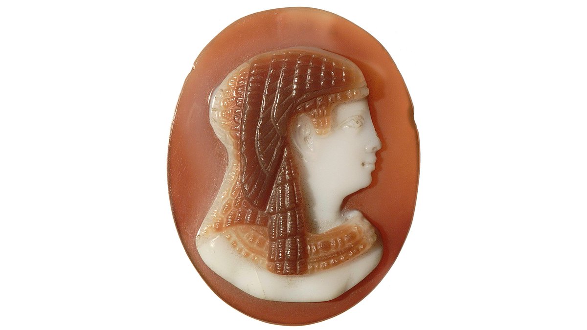 This Egyptian cameo depicts the head and shoulders of a mysterious Ptolomeic queen... possibly even Cleopatra herself, represented as the goddess Isis with a vulture head-dress.