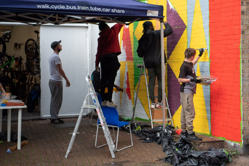 Poor_collective's tweet photo. During half term, young people from Carney's Community Boxing Gym helped paint their mural. The design features elements integral to their local community such as boxing, cooking and cycling.

Photo credit: Nick Cornwall 
https://t.co/cZTZrQWAwO

#young #people #community https://t.co/o6bwoqQE83