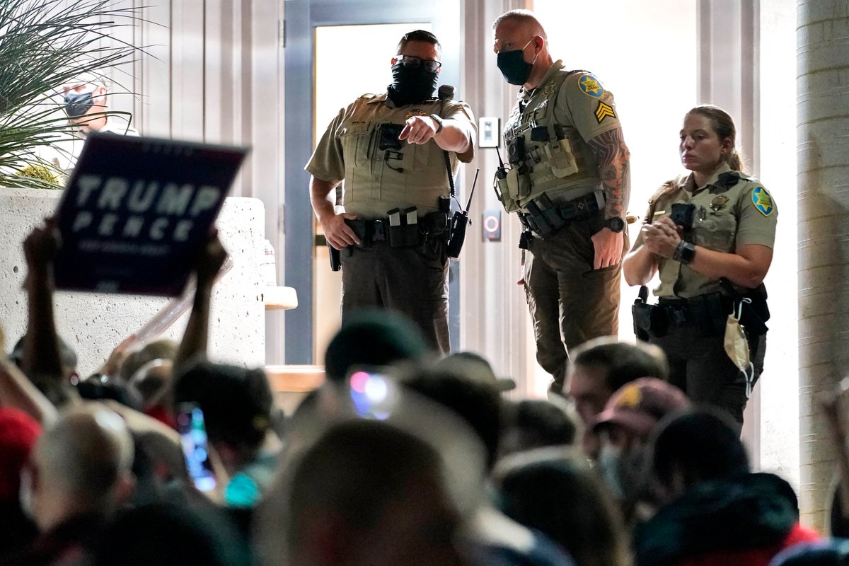 ajplus's tweet photo. 200 Trump supporters, some armed with AR-15s, surrounded a vote counting site in Arizona.

They claimed without evidence Maricopa County was not counting votes, while poll workers were doing just that. Election officials said staff "will continue [doing] our job." https://t.co/HomFTuvkiw