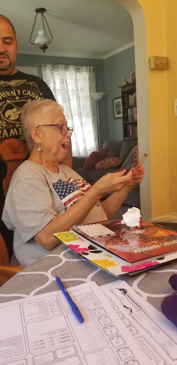 DndGrandma's tweet photo. While we await the conclusion of the season finale of the US, here is a distraction from the election white noise: Mom’s reaction with she saw @TheDeckofMany’s animated spell cards for the first time!
She is never without them at the table. #dndgrandma #dnd5e #deckofmany #ttrpg https://t.co/buu15BUfAr