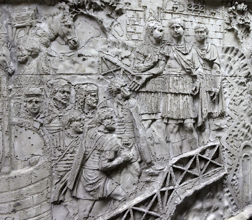 Scene 50 shows Trajan greeting arriving Roman soldiers (3). This is not a task strictly necessary for military success, yet Trajan does it because he cares about his peopleNote his relaxed pose and elevated position and stature, the pose of a man to be deified