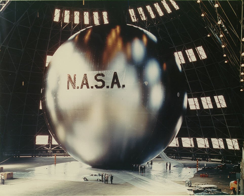i also stumbled on this photo of the Echo satellite. this was a test inflation of the ~100ft reflective sphere. it's a passive satellite with no electronics involved--it just bounces radio waves. the location of the picture looks vaguely familiar.