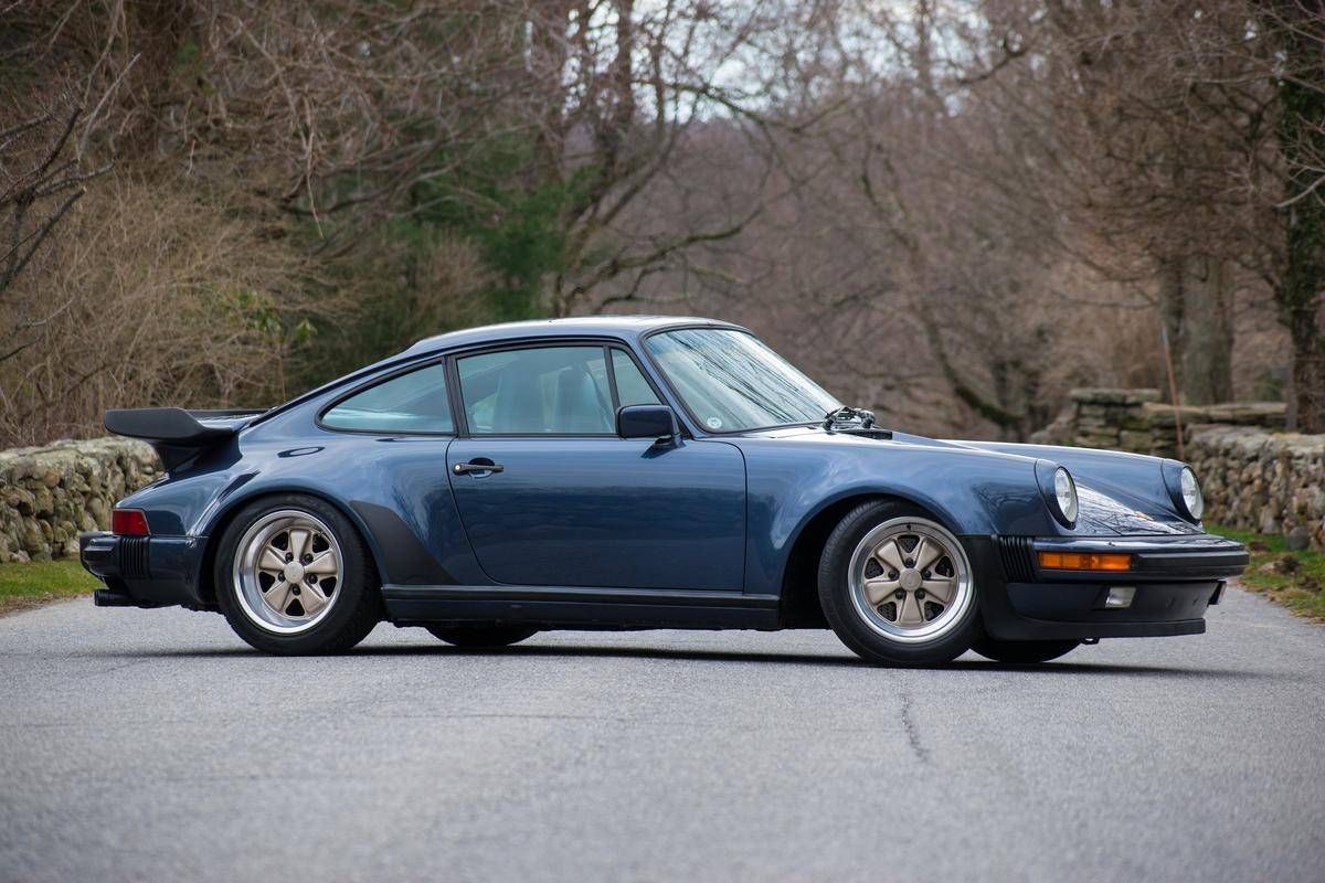 PorscheMarket's tweet photo. This 1986 #Porsche 930 Turbo Coupe was special ordered and finished in the rare Prussian Blue with a Dark Blue full leather interior. It only has 20k miles and is of course equipped with a manual transmission. #Classifind

▶️ https://t.co/uhnav33NIp https://t.co/wmECnFW7cD