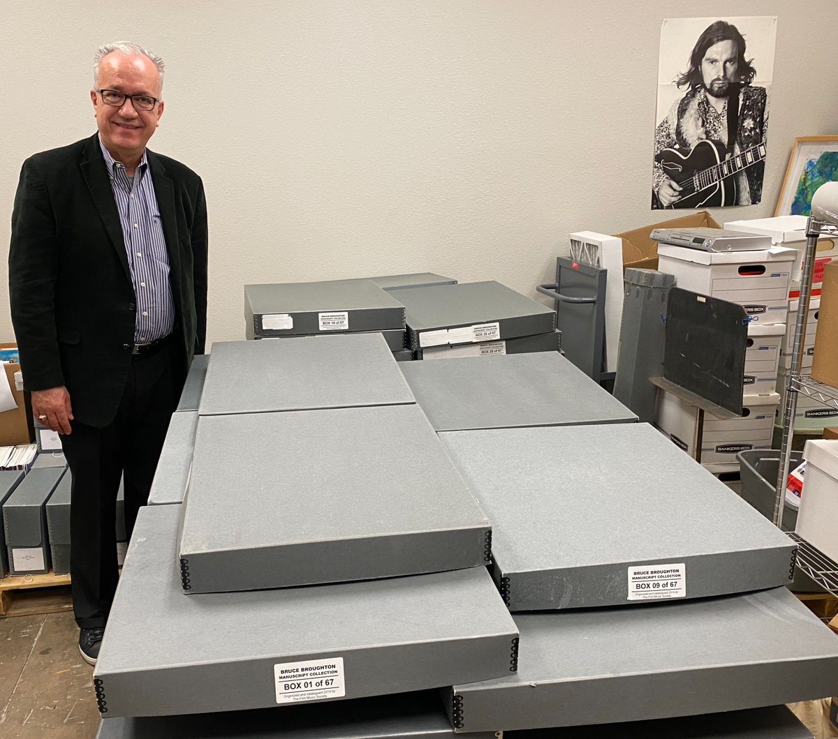 UNTCoM's tweet image. JUST IN: BRUCE BROUGHTON COLLECTION ARRIVES: John W. Richmond, Dean of the UNT College of Music, stands with 67 newly arrived boxes containing materials for the Bruce Broughton Collection. @JohnWRichmond2 @UNTPrez @untsystem @UNTnews @UNTsocial @The_SCL @ASCAP @UNTAdvancement