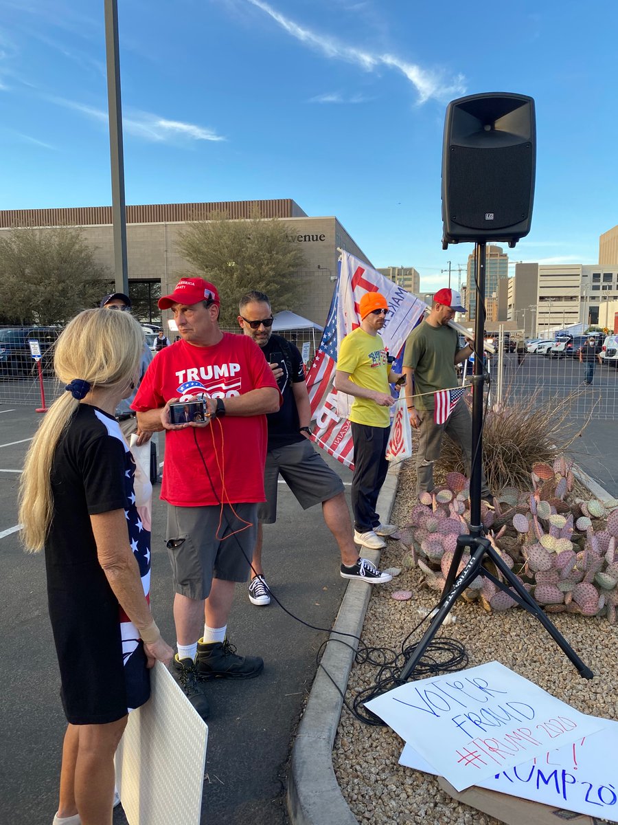 Everybody is standing in a semicircle around this guy’s cell phone. Cheers when Trump says he’s on track to win Arizona.