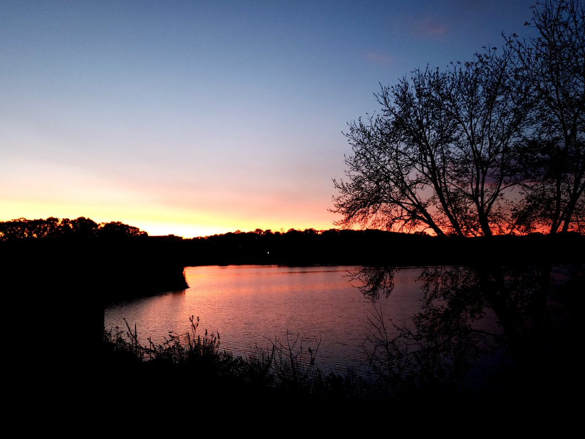The sun sets over Harris Pond in Woonsocket, R.I., and Blackstone, Mass., on Nov. 3