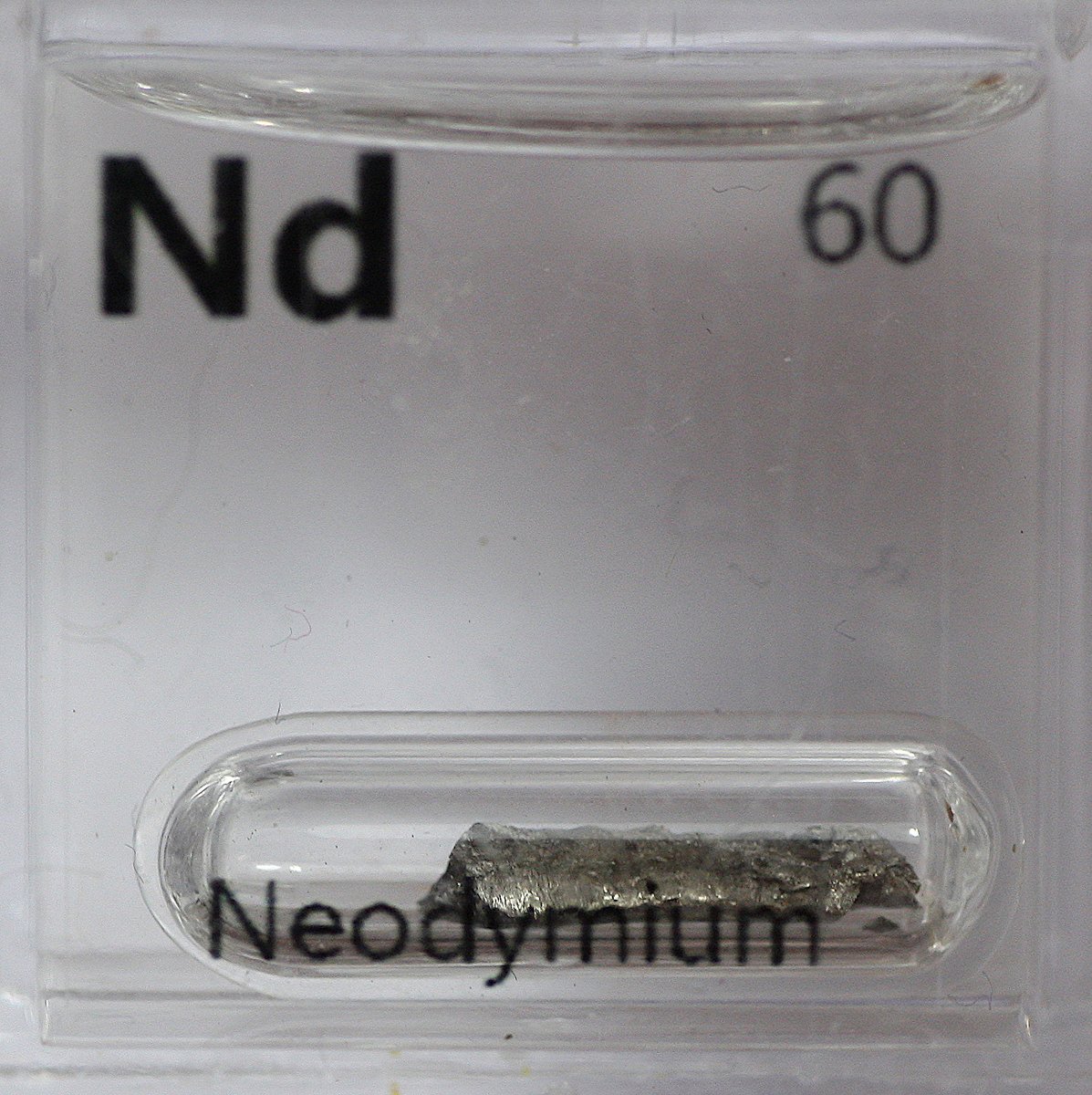 Neodymium  #elementphotos. Metal disc is a "neodymium magnet" (actually Nd2Fe14B), while the pink crystals are neodymium nitrate (Nd(NO3)3.6H2O).