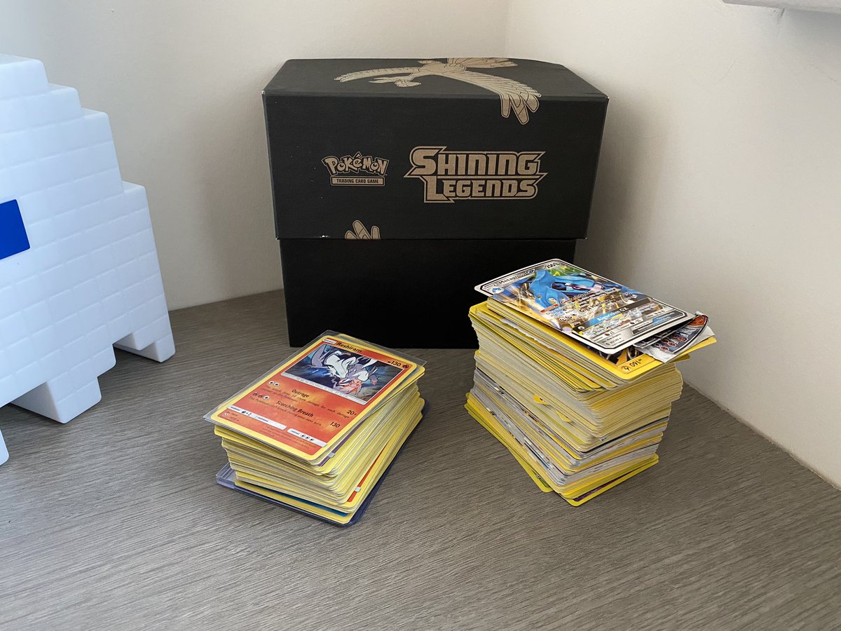 TCGFlips's tweet photo. I bought this card lot for £30 on ebay. The large stack of cards are all fake. Luckily for me, inside the small stack, i found a wild shining mew and ho-oh! Love the shining legends set. #ebay #PokemonCards #pokemon #shiningmew https://t.co/8FVOhTxKEV