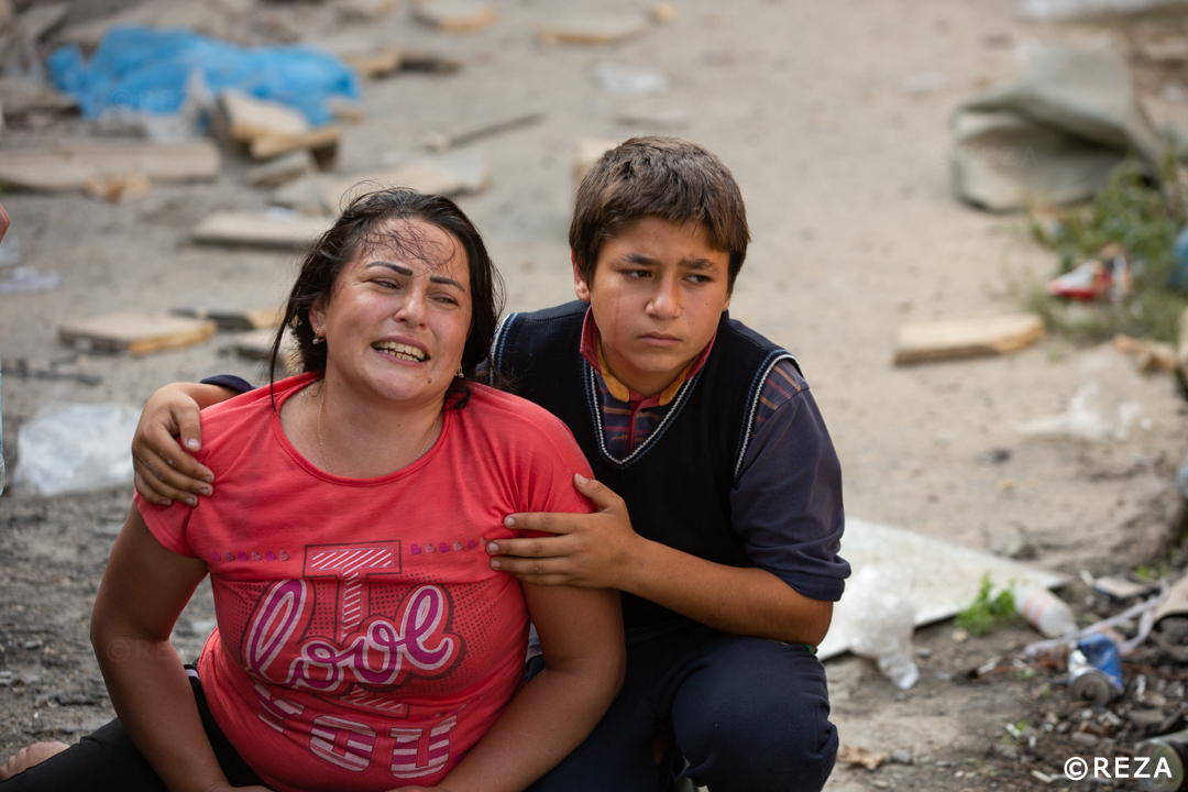 REZAphotography's tweet photo. This boy is holding his mother. They went to the grocery store together while the father, the husband stayed in the car patiently. He waited for his son and wife to come back when a bomb hit his car and burned him alive. #Barda #Azerbaijan #war #Karabakh https://t.co/cUflmCTvPJ