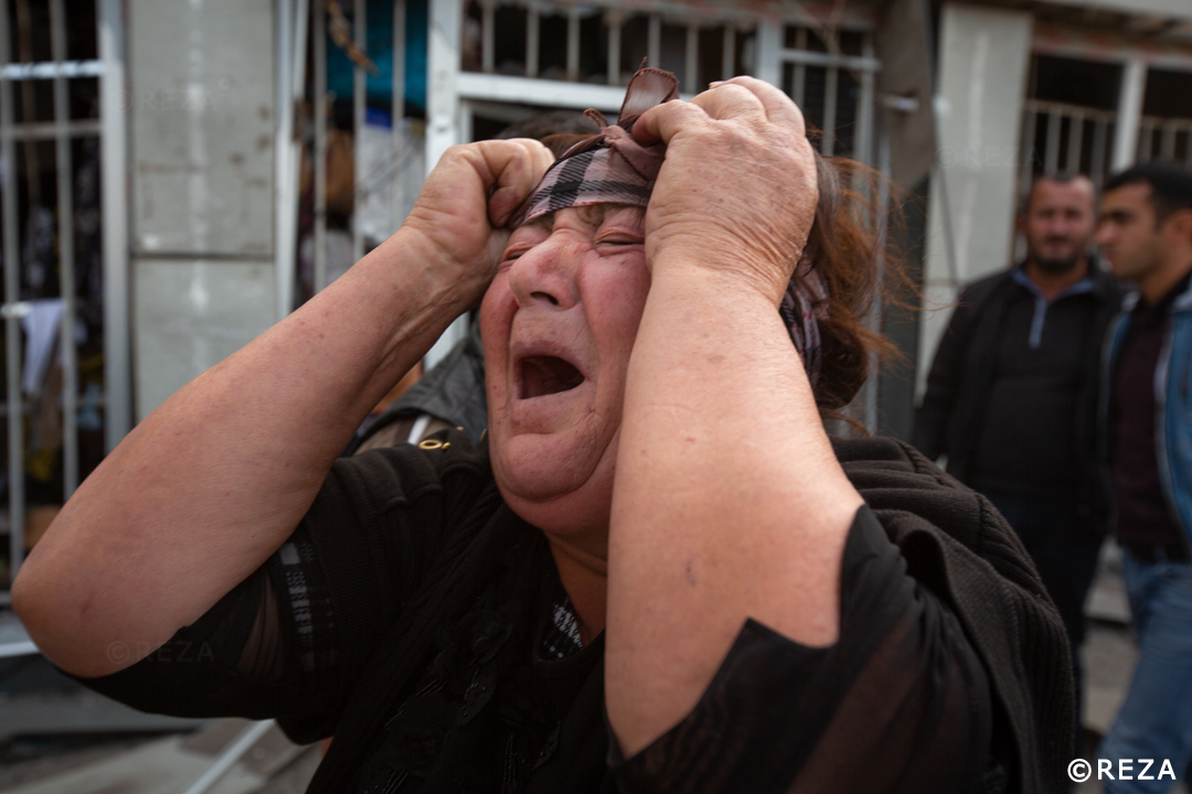 REZAphotography's tweet photo. This boy is holding his mother. They went to the grocery store together while the father, the husband stayed in the car patiently. He waited for his son and wife to come back when a bomb hit his car and burned him alive. #Barda #Azerbaijan #war #Karabakh https://t.co/cUflmCTvPJ