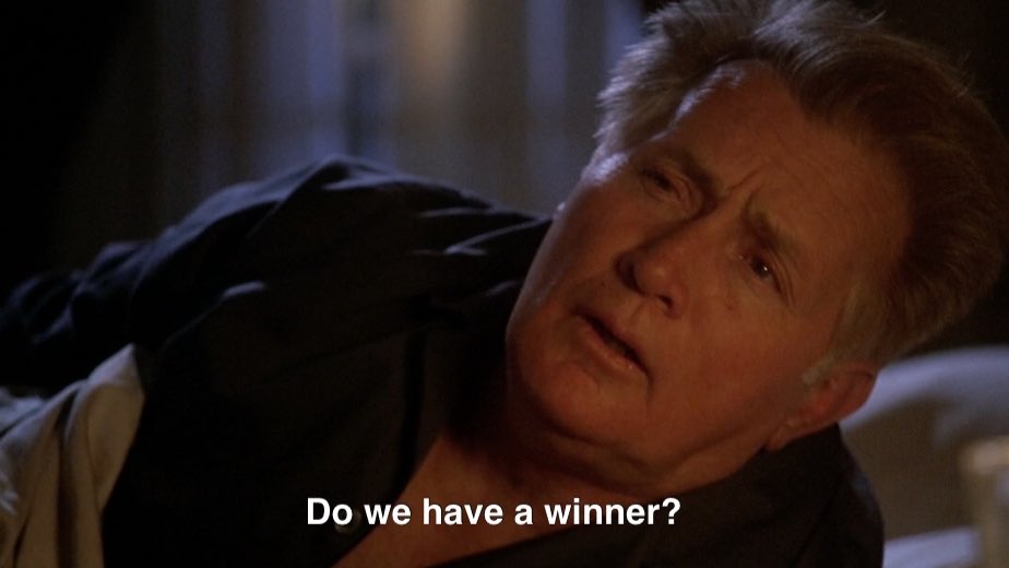 President Bartlet is half sitting up in bed with messy hair. He says “Do we have a winner?”