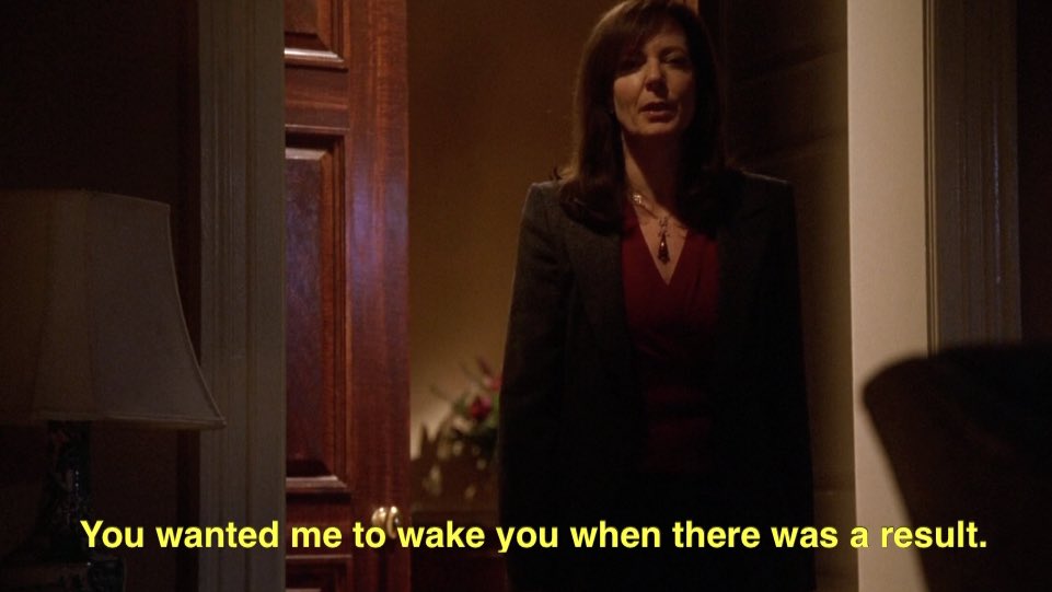 CJ stands in a doorway. She says “You wanted me to wake you when there was a result.”