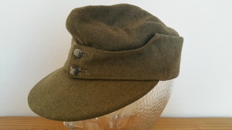 A Sdkfz253 of Sturmgeschütz Abteilung 191 in a Greek town, 1941 as men of 6th Gerbirgs Division pass by in a somewhat ragged Marschordnung formation.The Bergmütze (ski-cap) had a higher crown & shorter peak than the mid War general issue Einheitsfeldmütze.40)
