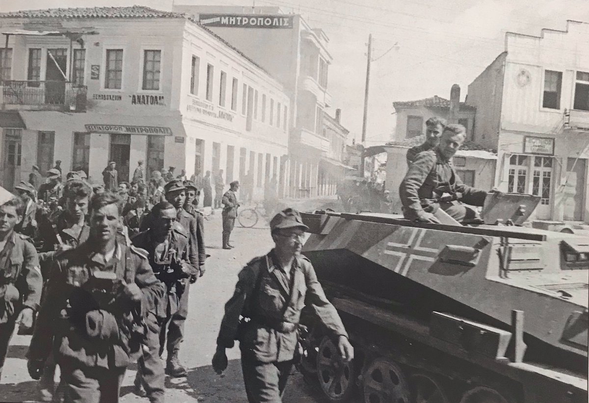 A Sdkfz253 of Sturmgeschütz Abteilung 191 in a Greek town, 1941 as men of 6th Gerbirgs Division pass by in a somewhat ragged Marschordnung formation.The Bergmütze (ski-cap) had a higher crown & shorter peak than the mid War general issue Einheitsfeldmütze.40)