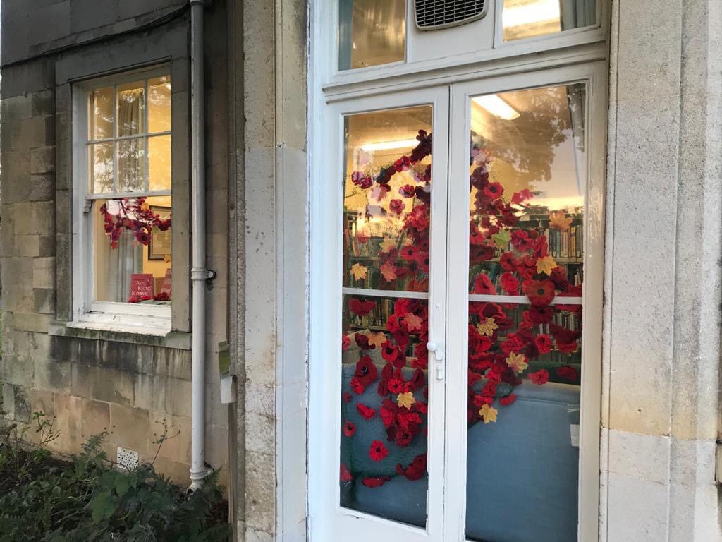 Uniting, across our busy road with the a Garden of Remembrance, the library poppies shine in the dusk #PoppyAppeal #lestweforget2020