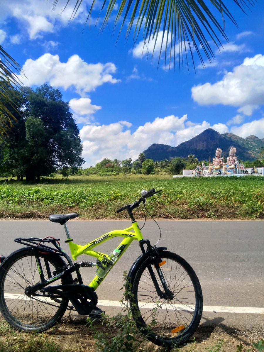 The route was so beautiful, I couldn't stop taking pictures literally every 10 minutes.The guardian idols, Munis, in the middle of the field A selfie with the Munis & a beautiful portrait of my cycle against the lit sky  #countryroads  #cycling  #cyclinglife  #Mallur/3