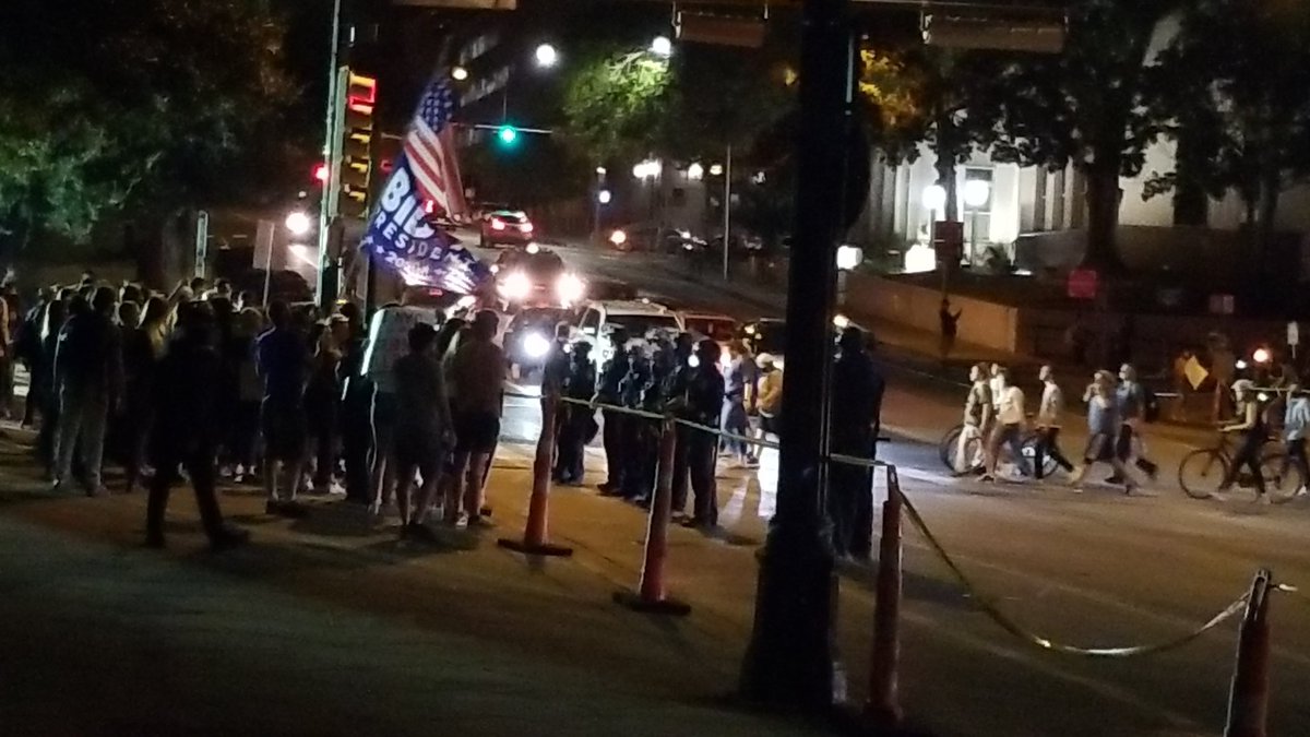 With many Trump supporters cleared out,  Biden supporters cross 11th St amid continued heavy police presence.