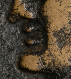 We can also see that fairly significant recessions in the die were used to form the mouths and eyes, a departure from coins minted in Rome.