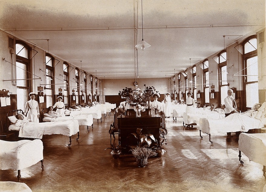 The old Nightingale style wards had rows of beds down each wall. A few nurses could have sight of many patients, and easily communicate with each other. If a patient has a problem (e.g. cardiac arrest) it is easy to spot and help arrives faster. Photo: Wellcome Collection. 3/10