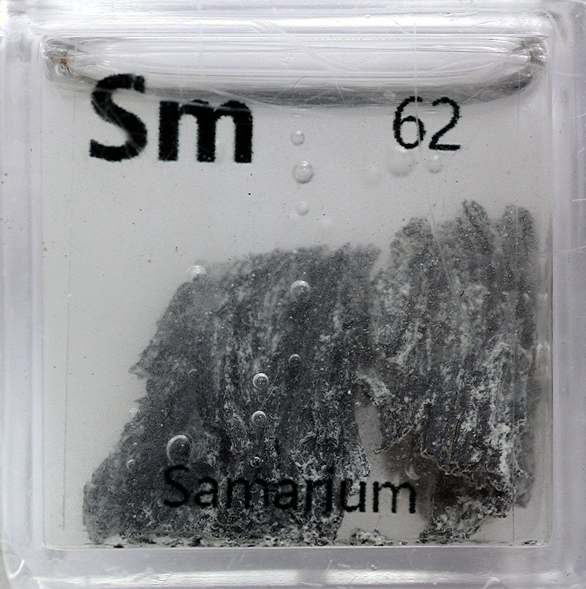 Samarium  #elementphotos. Sm is sensitive to oxidation, as can be seen for these samples. Metal pellet is a samarium-cobalt (SmCo5) magnet.