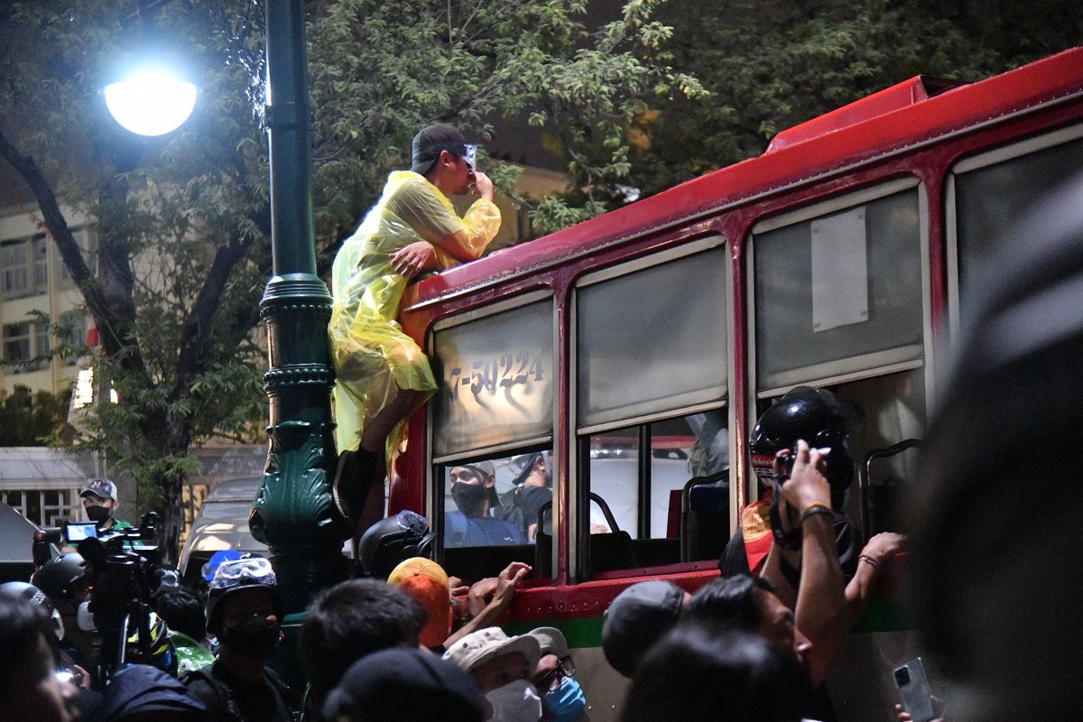 Nice view? A protester climbs up a bus to scout at the police position during a faceoff close to the Grand Palace.  #ม็อบ8พฤศจิกา  #Thailand  #KE  #whatshappeninginthailand