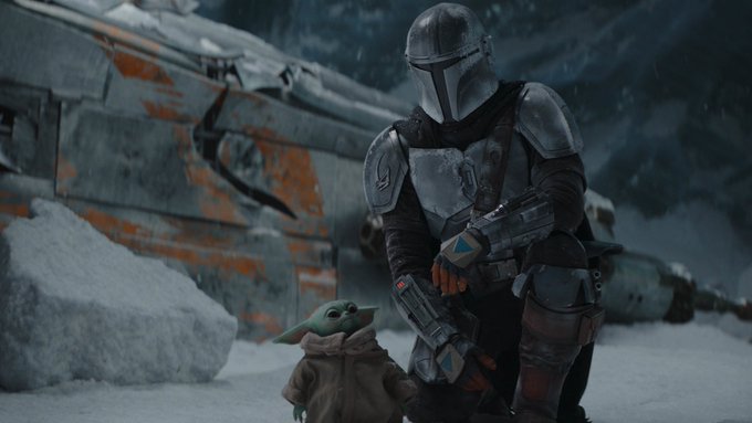 The Mandalorian kneels down next to The Child.
