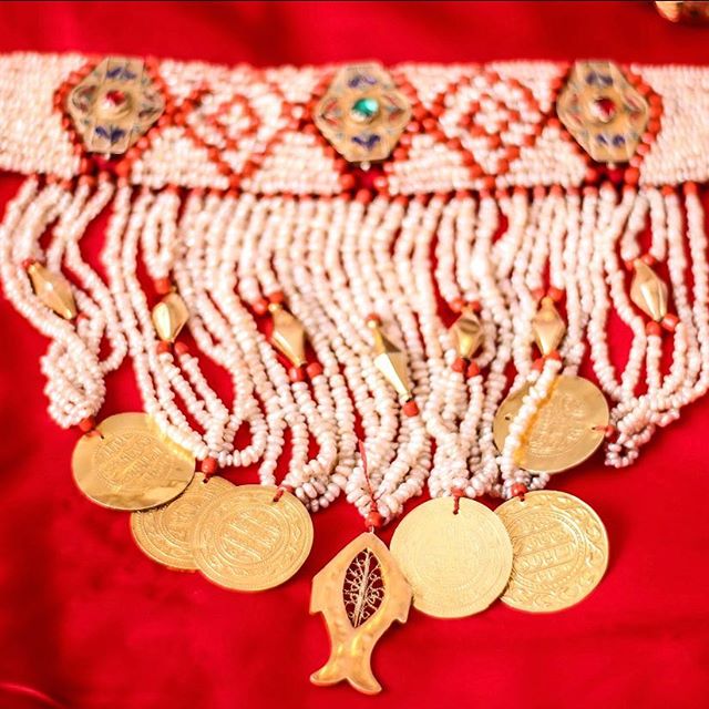 1) In Tunisia, if you look closely at details, you can find fish symbolism EVERYWHERE:Doors, jewelry, dresses, walls, windows, mosaics, songs, expressions "7outa 3lik" etc...Sometimes you can even find actual fish tails hanging around!Fish symbolizes fruitfulness and luck.