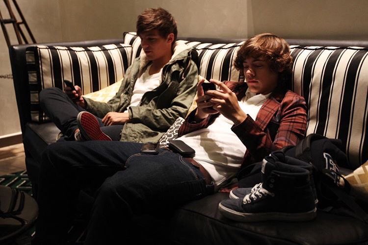 Harry : im sitting on the sofa next to you...you look sexy Louis : hahaha I am being slowly seduced by your curls Harry : I know..that was my plan