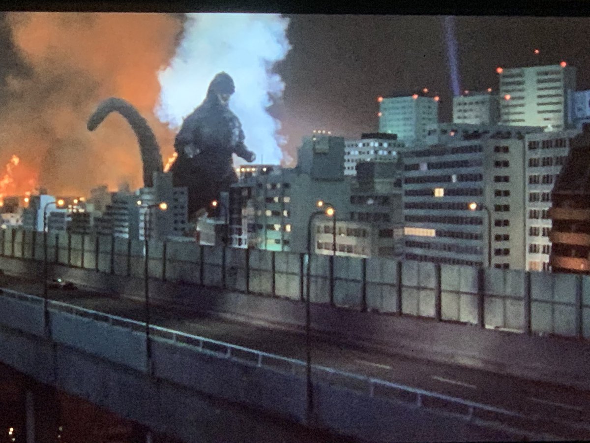 Godzilla destroying cities.