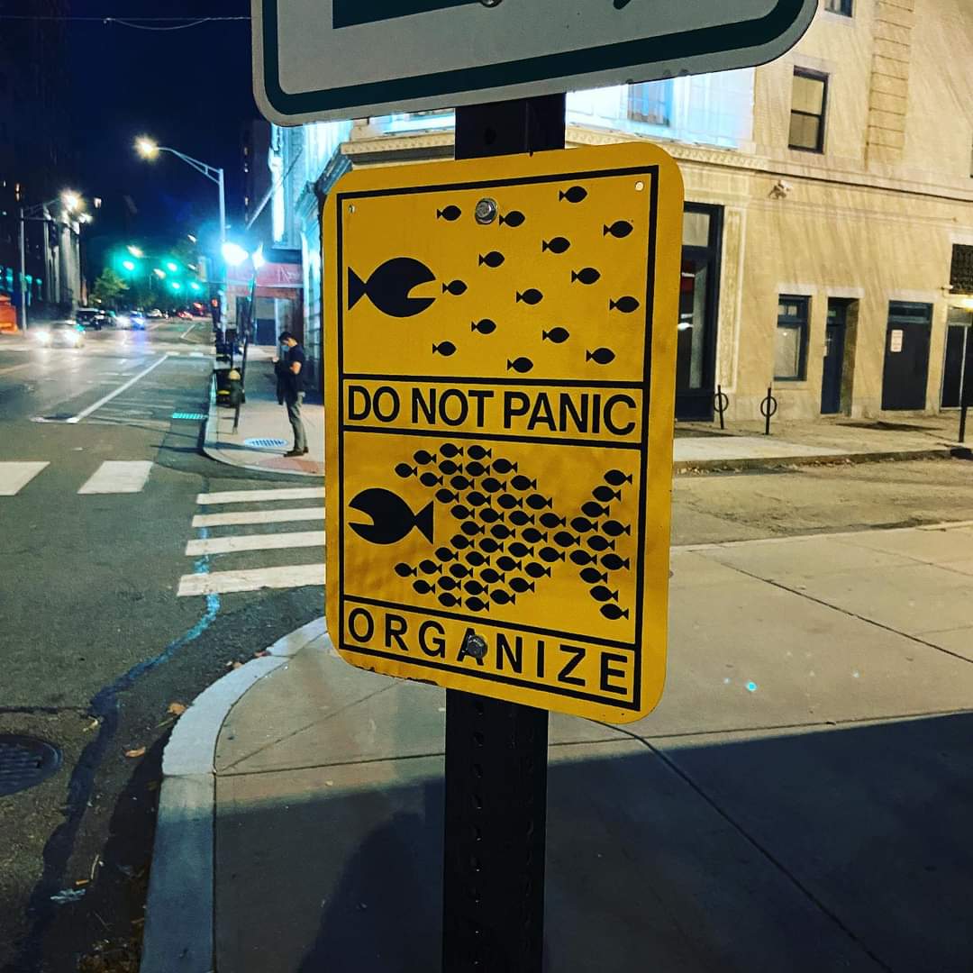 UpriseRI's tweet photo. A sign has appeared near the 'Trinity' skate park in Providence. This is at least the second time and second form that the "Do Not Panic. Organize" graphic has been posted in the city, as a stencil of this same graphic was put up near I-95's Exit 23 in September. https://t.co/Gkf4RDTtXZ
