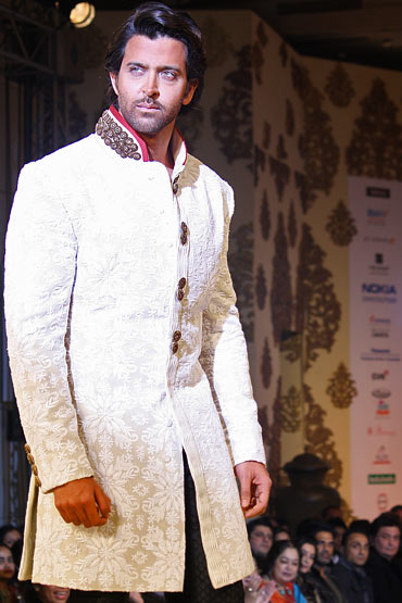 7. You may wanna don this princely sherwani with a heavily embroidered collar and a black churidar pajama. Trim that stubble and opt for a set hairstyle.  #HrithikRoshan