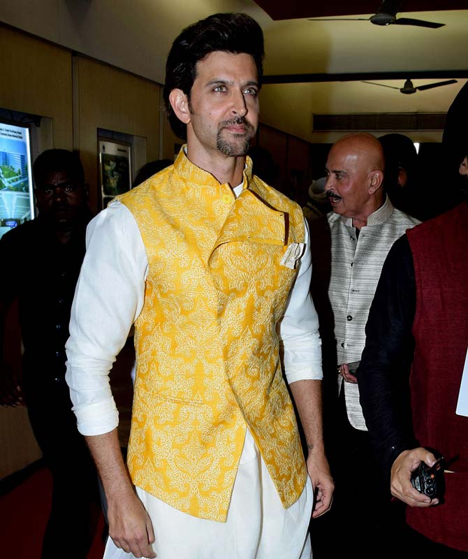 8. Have it in you to rock yellow? Get your hands on this heavily embroidered yellow jacket - paired it with cream/white kurta-pajama and a pocket square too! #HrithikRoshan