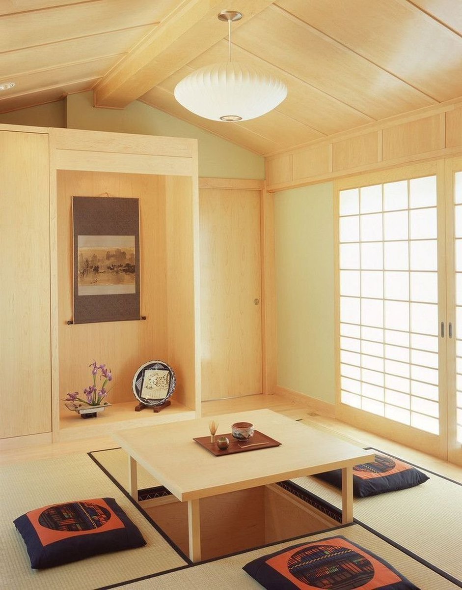 The room also evokes inspiration from Eastern design. In particular, the bonsai, the door shape, and the light panels in the back remind me of Japanese minimalist interior design. +