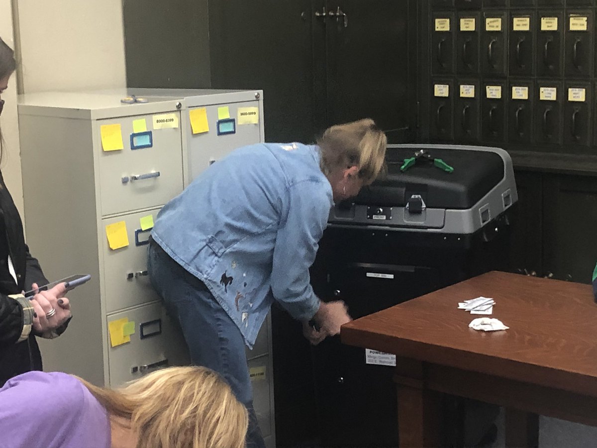 The opening of the Clear Creek Poweshiek counting machine. Ballots had been sealed inside plastic shrink wrap type bags and locked inside the machine since the recount of Saturday. Note the clippers used to cut open the metal seal.  #IA02  #iapolitics