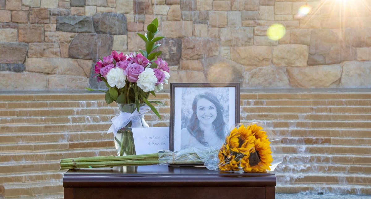 Photo and flowers on top of table.