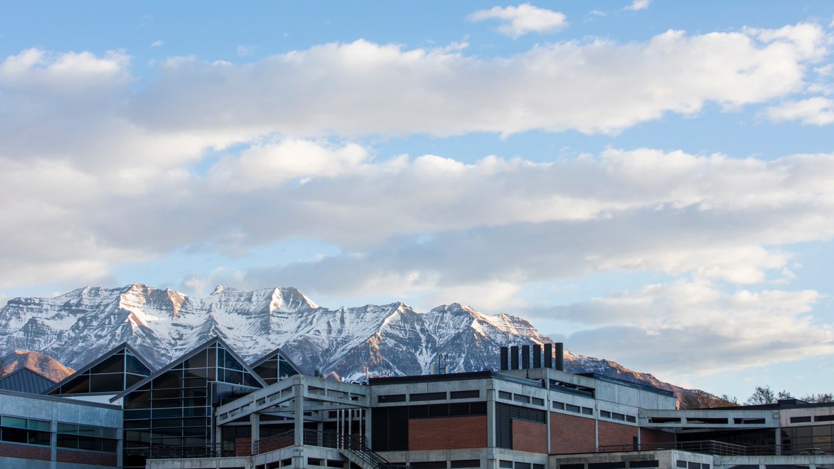 Snowy mountains behind campus buildings.