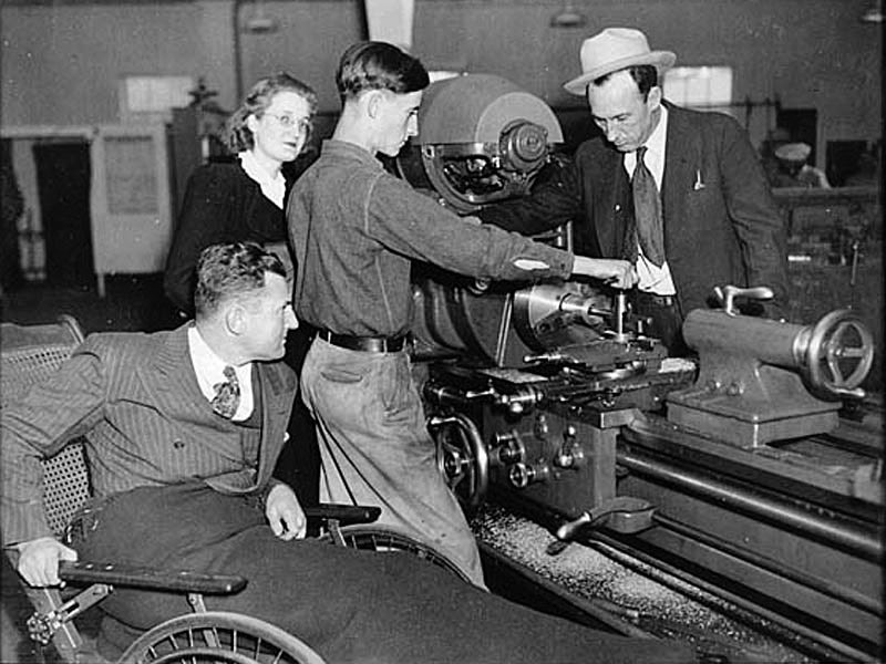 And here’s Fortson hand-pollinating a tree with a feather duster, like a hobbyist nurseryman, and also checking out an industrial lathe, and I’m including these just because I like plant genetics and manufacturing, too, and would have liked to have been there.