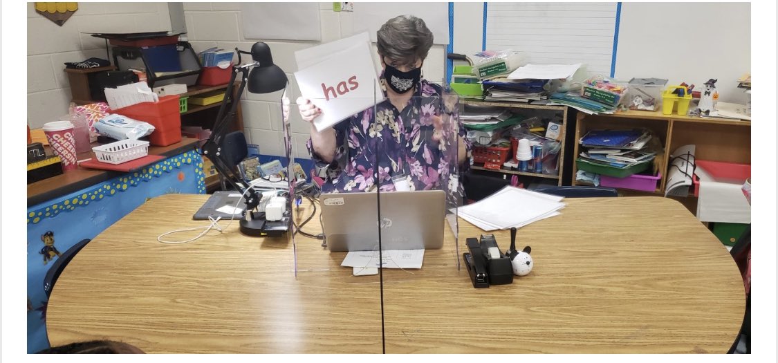 WLE_HCS's tweet photo. Kindergarten teacher, Ms. Pickel, is using a sneeze guard while working with a small group on sight words. #MaskUpHenry #SafetyFirst #DolphinNation🐬 https://t.co/AwZ7LiznAH