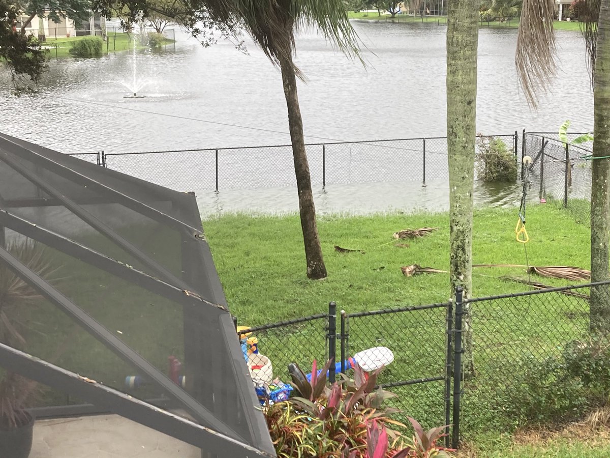 BenIsenberg's tweet photo. @EricBlake12 @CoCoRaHS Hi Eric, Davie over here.  Not sure the exact total, but we still have rain in our streets and about 20% of my backyard is occupied by the lake.  The fence is the end of the backyard. https://t.co/SgIOWaJItF