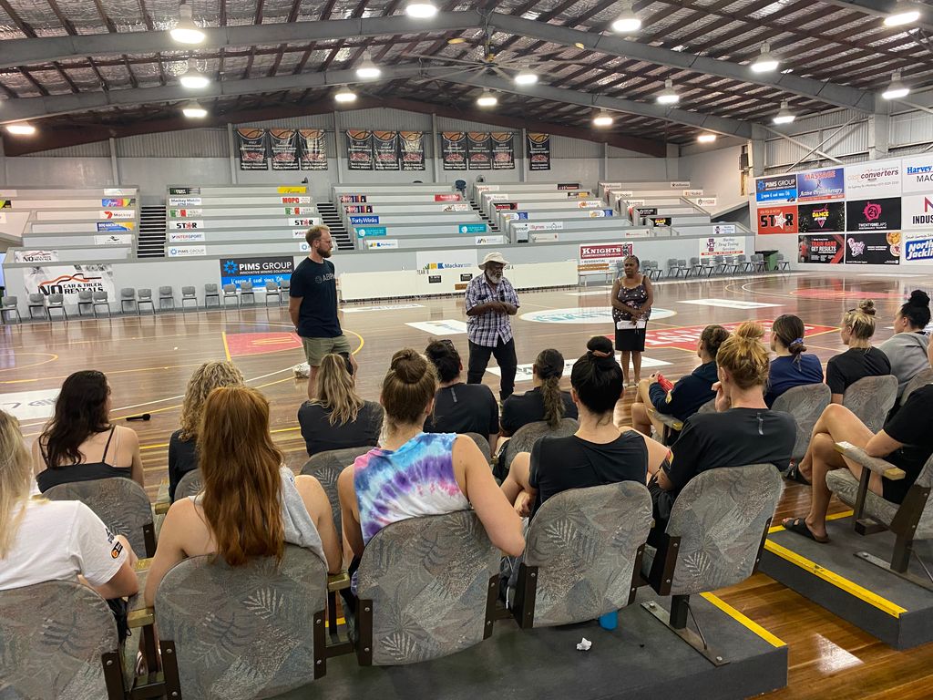 AusBasketballPA's tweet photo. With #WNBL20 tipping off tonight, players were Welcomed to Yuwi Country by Aunty Pat and learned valuable cultural insights about the Yuwi people from Uncle Gary in Mackay. It was an incredible honour and we can't wait for the season to get underway! #Yuwi #AlwaysWasAlwaysWillBe https://t.co/tjAgQ7Nmri