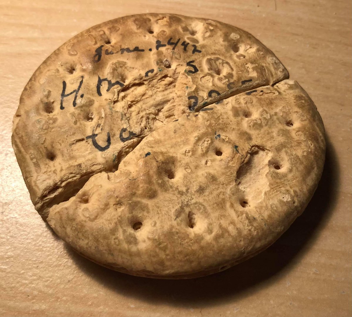 But here's my favorite piece... a biscuit. From what I've read, sailors would be given super dry crackers. They lasted forever. On one side, it seems to say June 26, 1942... HMCS Camrose. But it's the other side I love...
